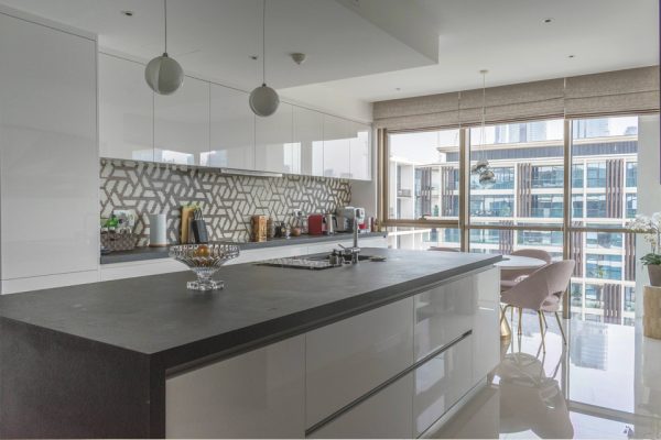 Kitchen Interior Design - Ball pendant lighting above granite kitchen counter with modern wall backdrop & large window panes