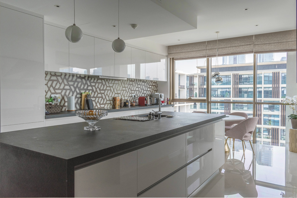 Kitchen Interior Design - Ball pendant lighting above granite kitchen counter with modern wall backdrop & large window panes