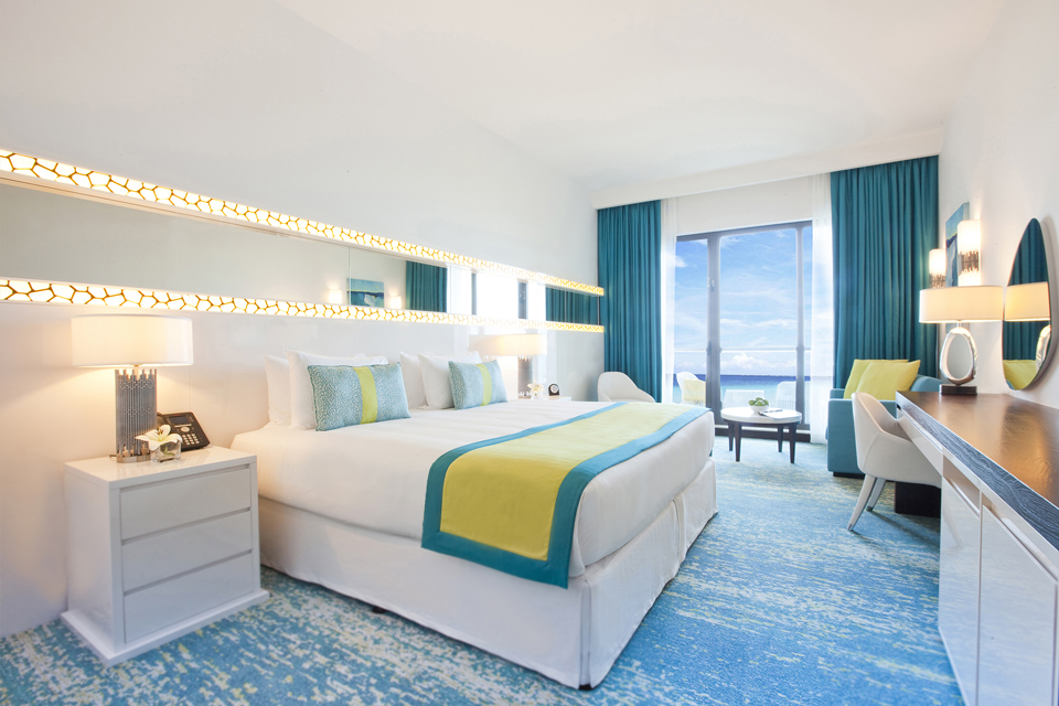 Hotel Design - White furniture on laminated blue & white textured floor with matching blue curtains & patterned wall lighting