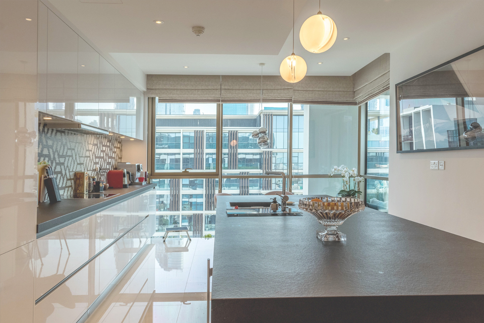Kitchen Interior Design - Ball pendant lighting above granite kitchen counter with modern wall backdrop & large window panes