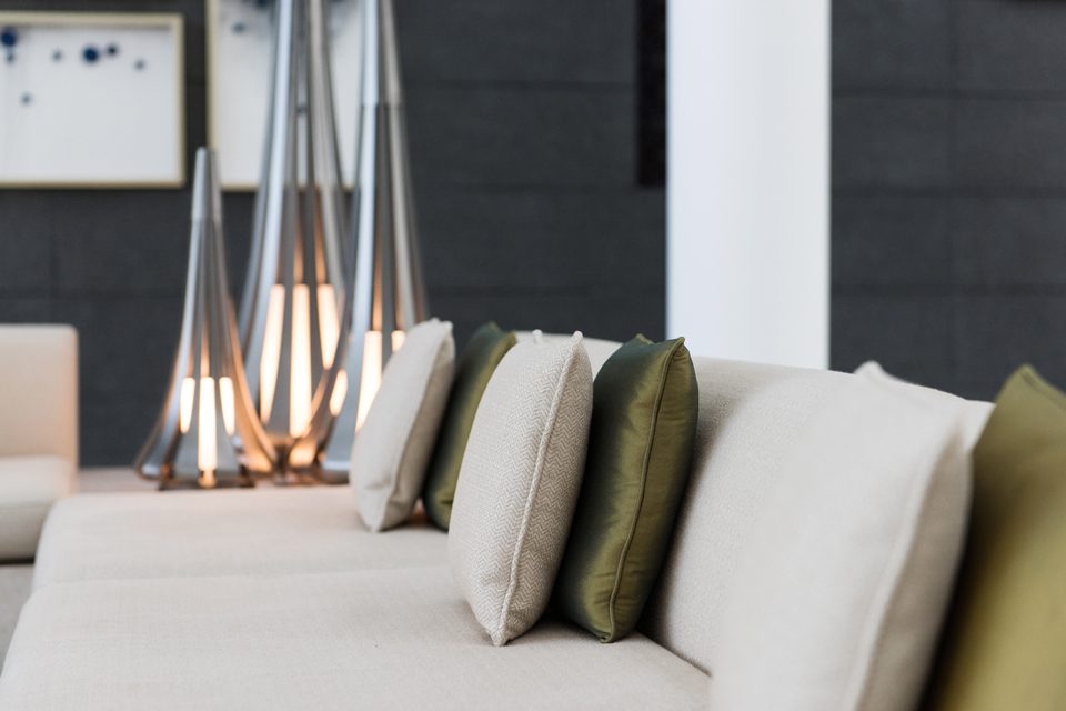 Interior Decorating - Teepee shaped silver lamps behind luxury couch and cushions