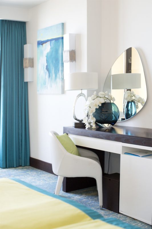 Bedroom Interior Styling - Modern white & dark wood furniture with shaped mirror & wall art matching blue curtains