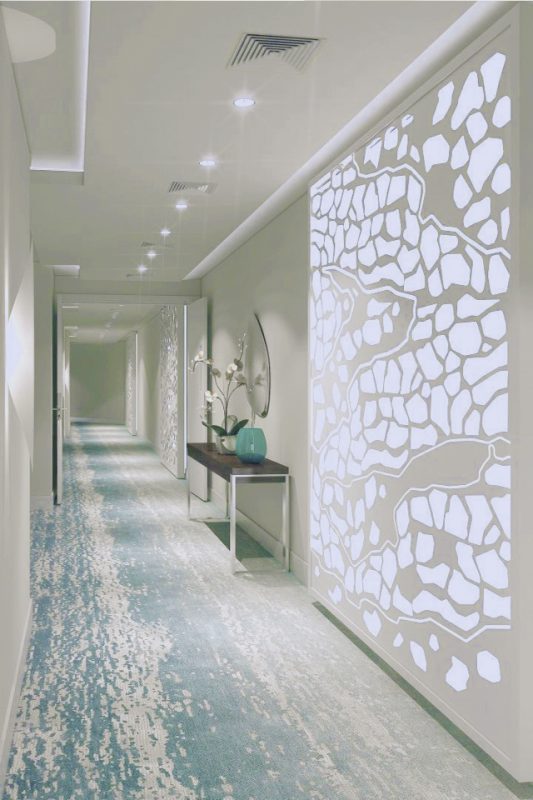 Hotel Passage Interior Design - Lighting feature on wall with textured blue & white floor below ceiling lights
