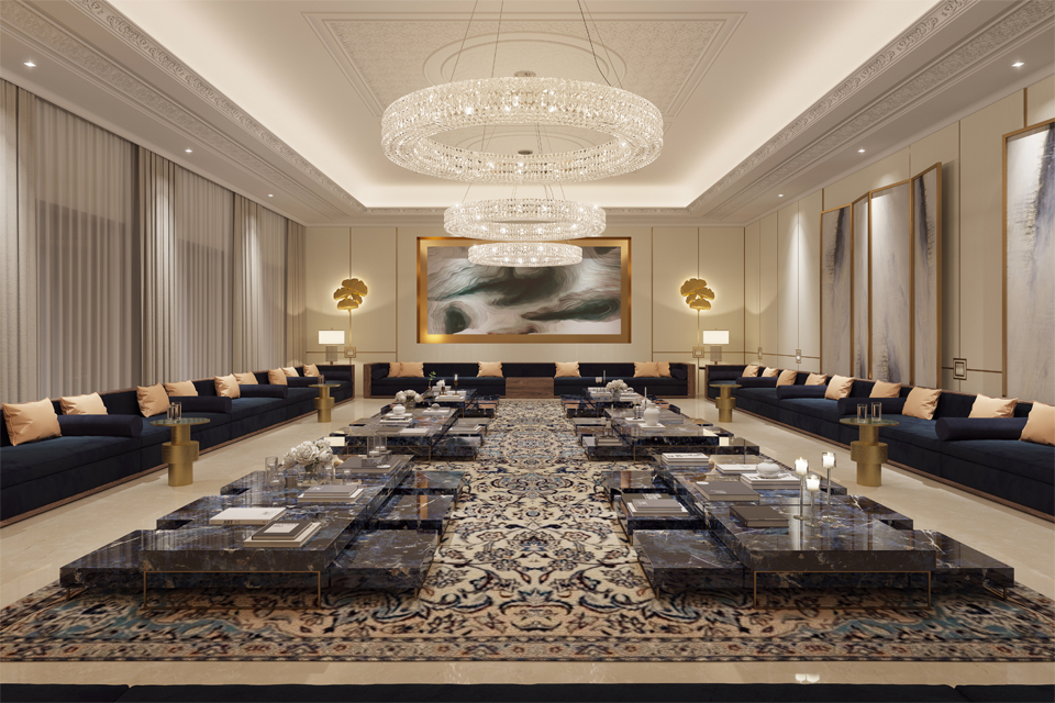 Majlis Design - Marble tables on large Persian rug, surrounded by navy sofas, gold side tables & under a modern chandelier